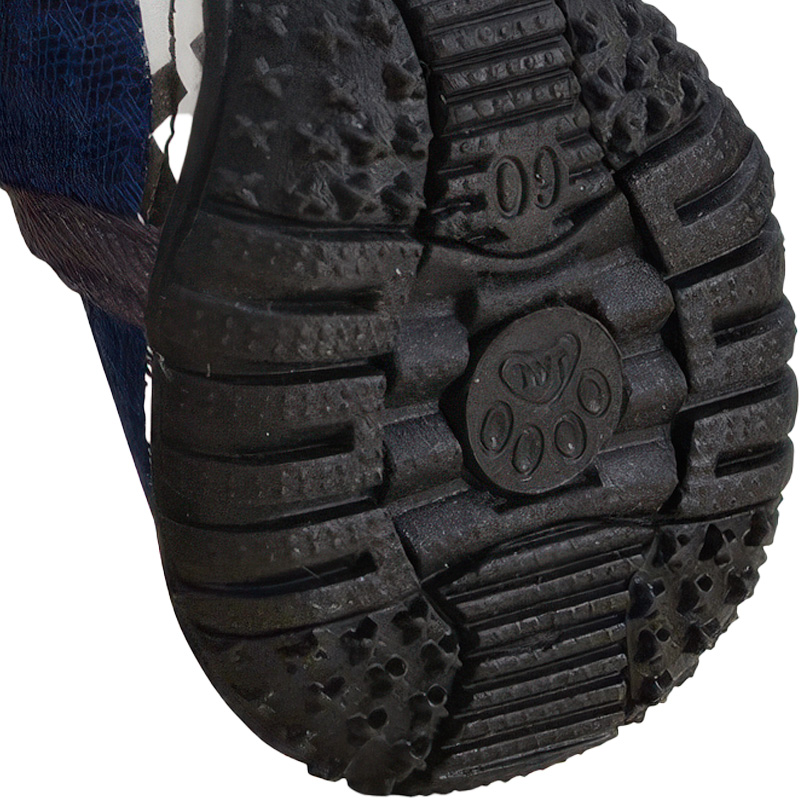Underneath macro of dog shoes for large dogs showcasing the thick resilient rubber sole and paw pad relief motif.