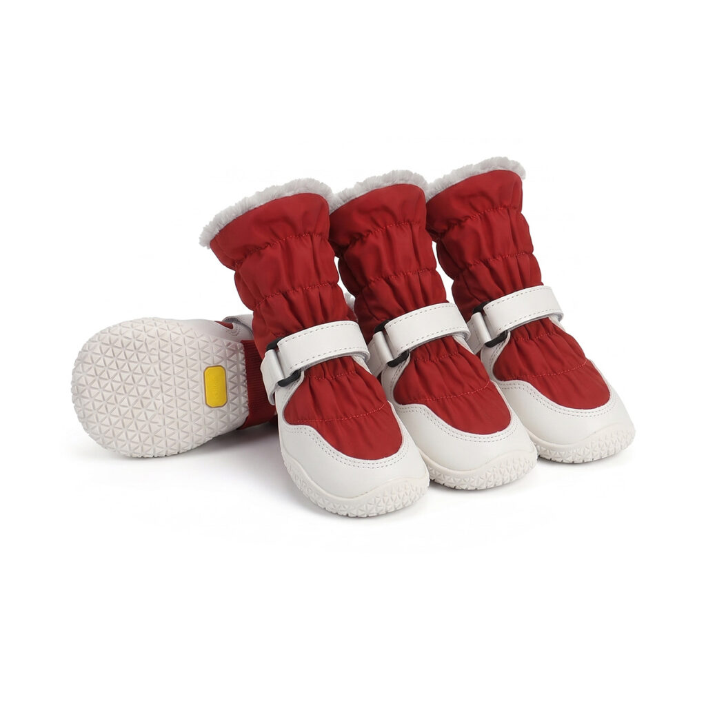Drawstring fleece dog boots in crimson red featuring thick white thermal lining cuffs and durable non-slip rubber soles.