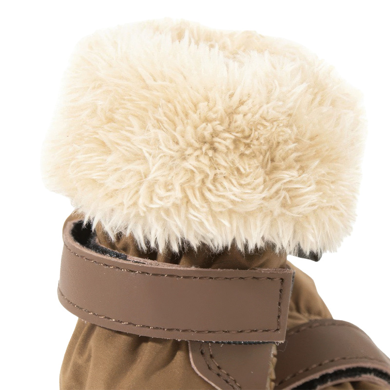 Close-up of the adjustable drawstring collar toggle and thick plush white fleece lining on winter warm dog boots.