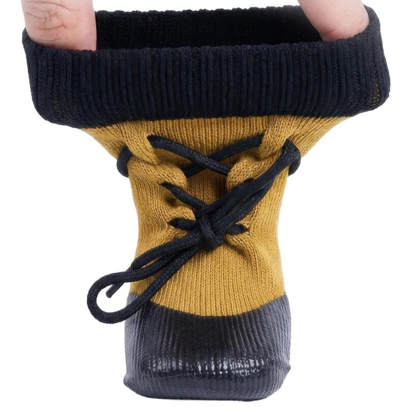 Hands stretching the high-elastic ankle cuff of camel tan drawstring knit dog booties to show elasticity.