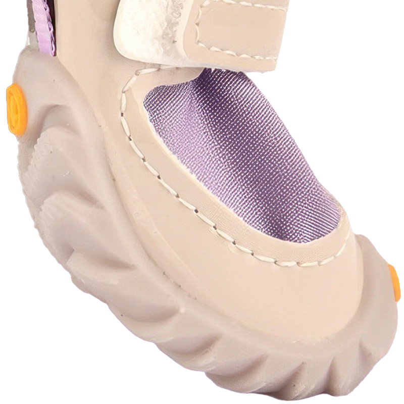 Side profile view of easy-on-off dog shoes demonstrating the anatomical mud guard chassis and expandable throat.