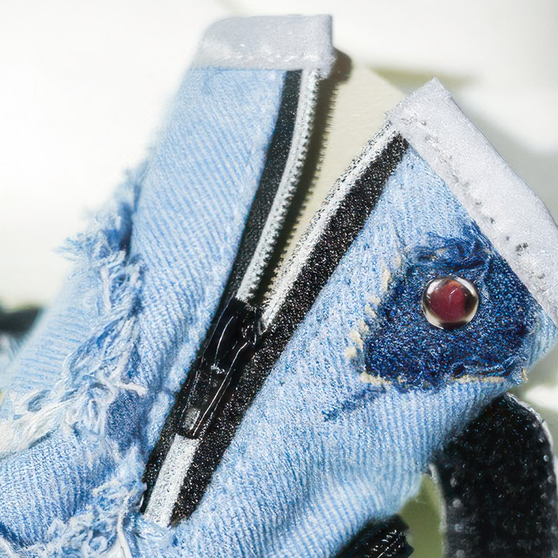 Technical view of easy-on-off dog shoes with zipper throat opened wide alongside the double wrap strap hook panel.