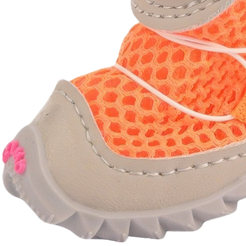 Front profile detail of an orange dog shoe showing a grey faux leather mudguard boundary and wrapped rubber toe cap box.