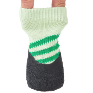 Fingers stretching the highly resilient cuff of sage green elastic cuff knit dog booties to show structural stretch.