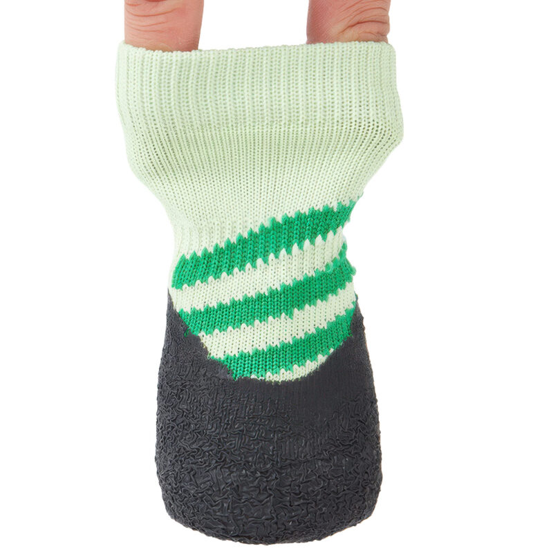 Fingers stretching the highly resilient cuff of sage green elastic cuff knit dog booties to show structural stretch.