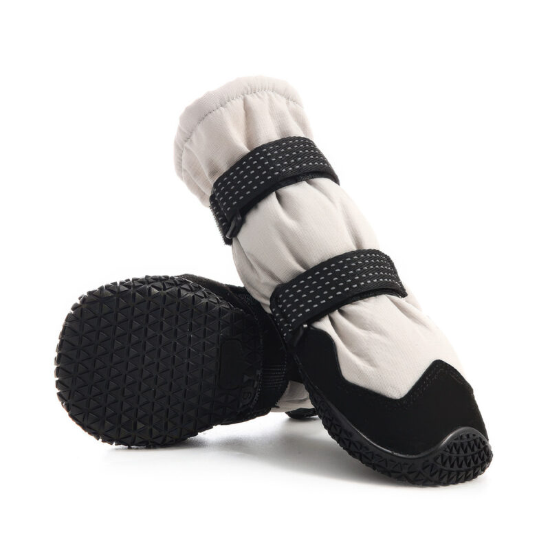 Heavy duty outdoor dog boots showcasing the unyielding automotive tire pattern matrix on the flexible rubber base.