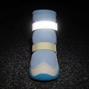 High-top dog boots for large dogs showing the bright retroreflective top strap glowing under night conditions.