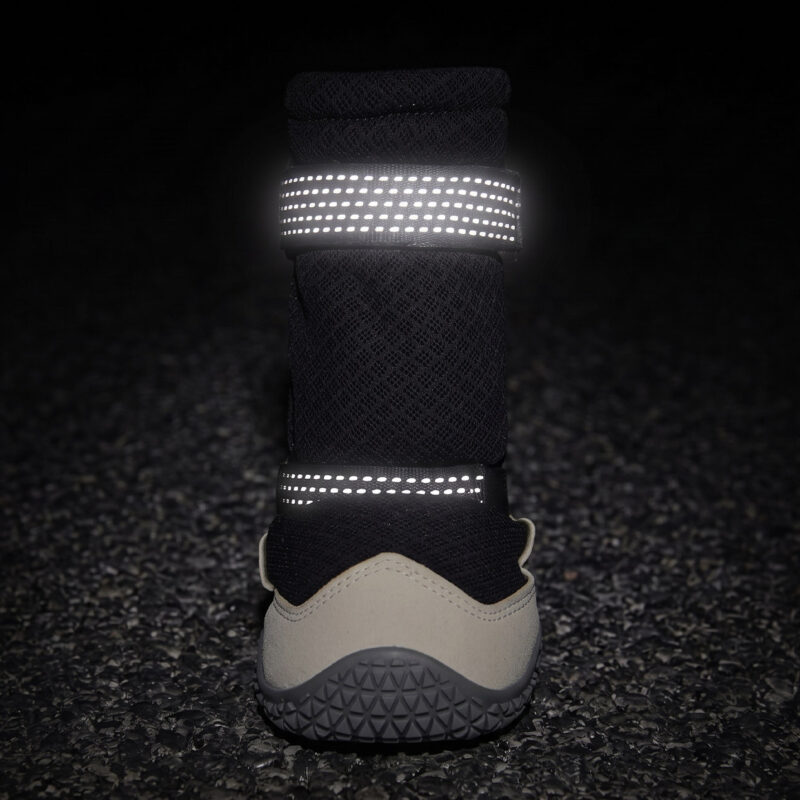 Dual-sided High-visibility Safety Reflective Webbing for Secure Night Outdoor Walking Retroreflective straps on protective hiking dog boots glowing bright under night light conditions.