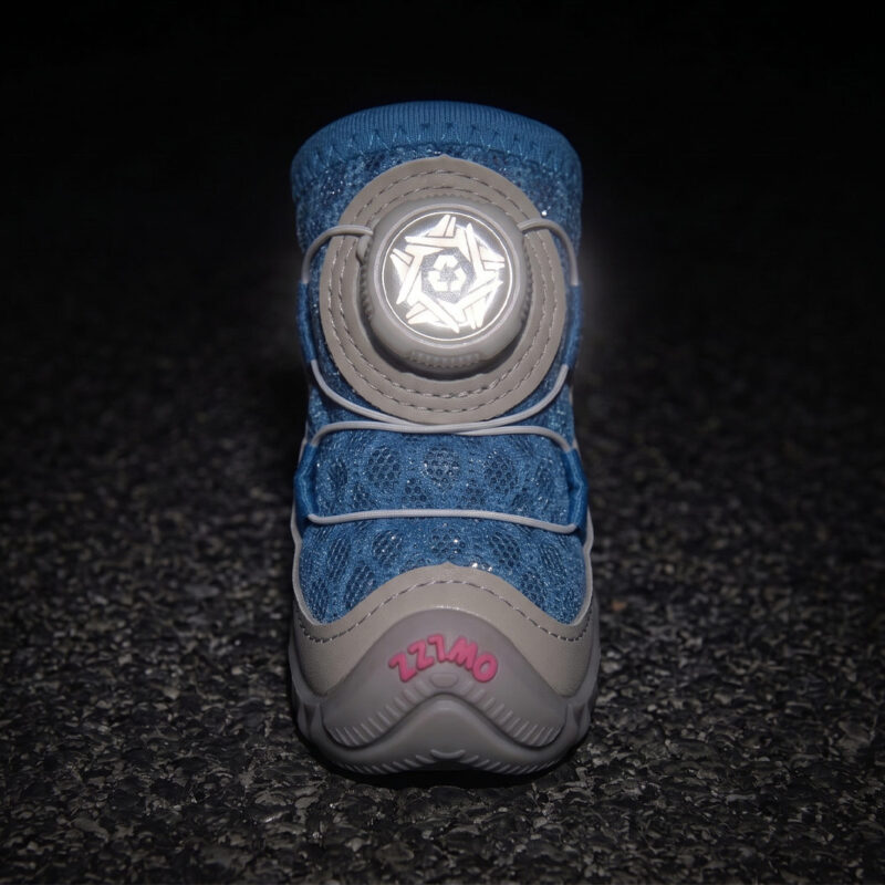 High Visibility Night Safety Reflective Dial Glow Front view of a blue honeycomb mesh dog shoe with its white circular mechanical dial face glowing under darkness.
