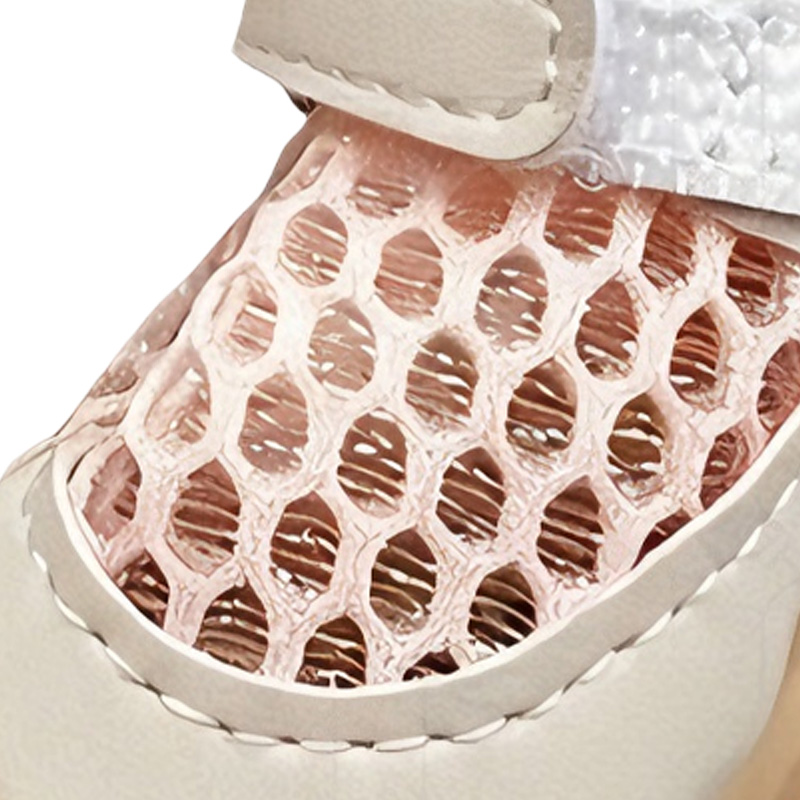 Macro close up of honeycomb mesh dog shoes showing the multi dimensional ventilation grid and lining layers.