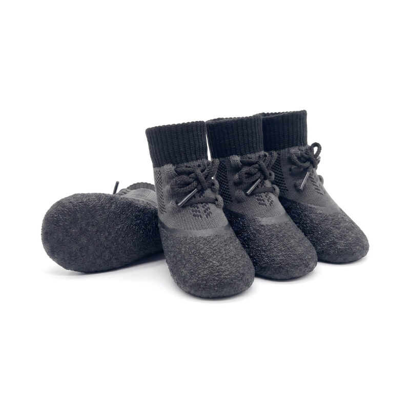 Stealth black lightweight running dog socks featuring a secure lace-up closure and flexible textured rubber bases.