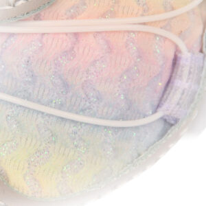 Macro view focusing on the glitter-infused rainbow pastel canvas and white tension wire of protective dog shoes.