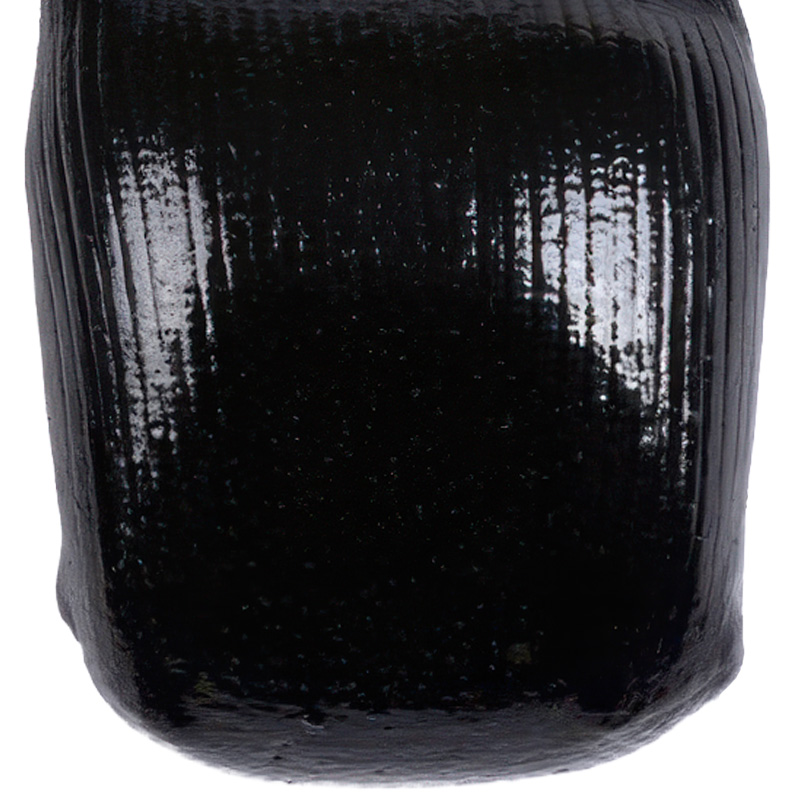 Macro view of the high-friction polished black outsole tread on no-slip socks for hardwood floors.