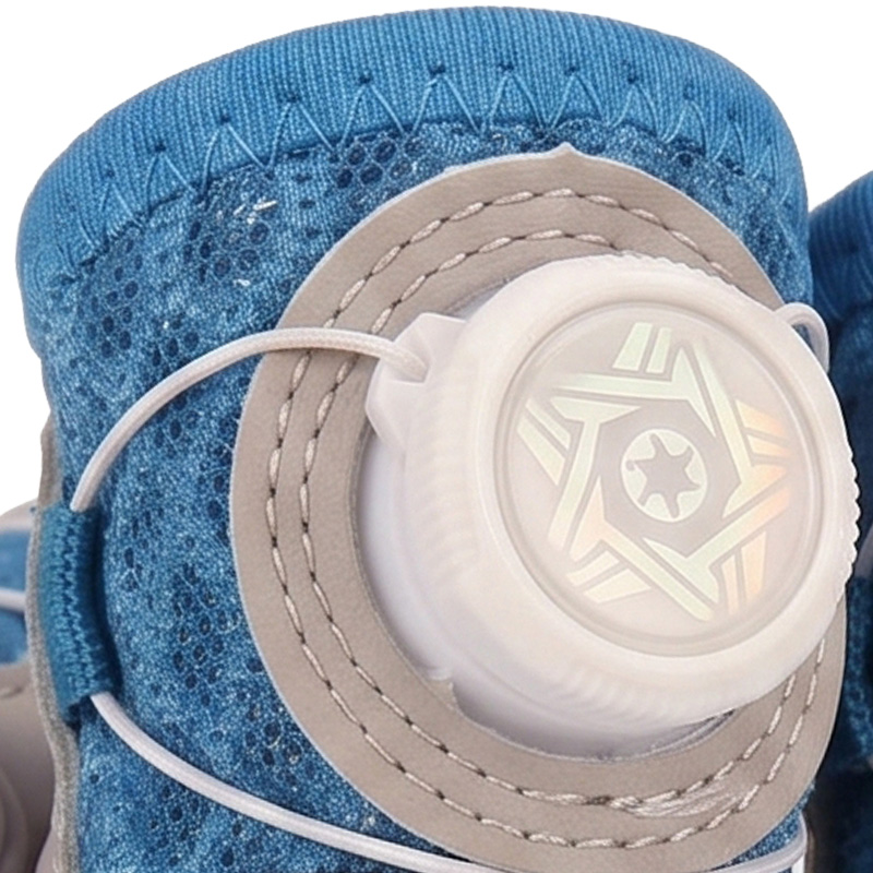 Macro view focusing on the white rotating adjustment dial and stitched leather guide paths on blue pet booties.