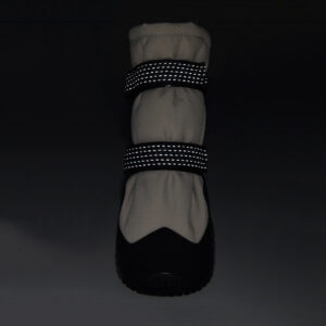 Dual 3M retroreflective straps glowing bright on reflective double-strap shoes under dark environment conditions.