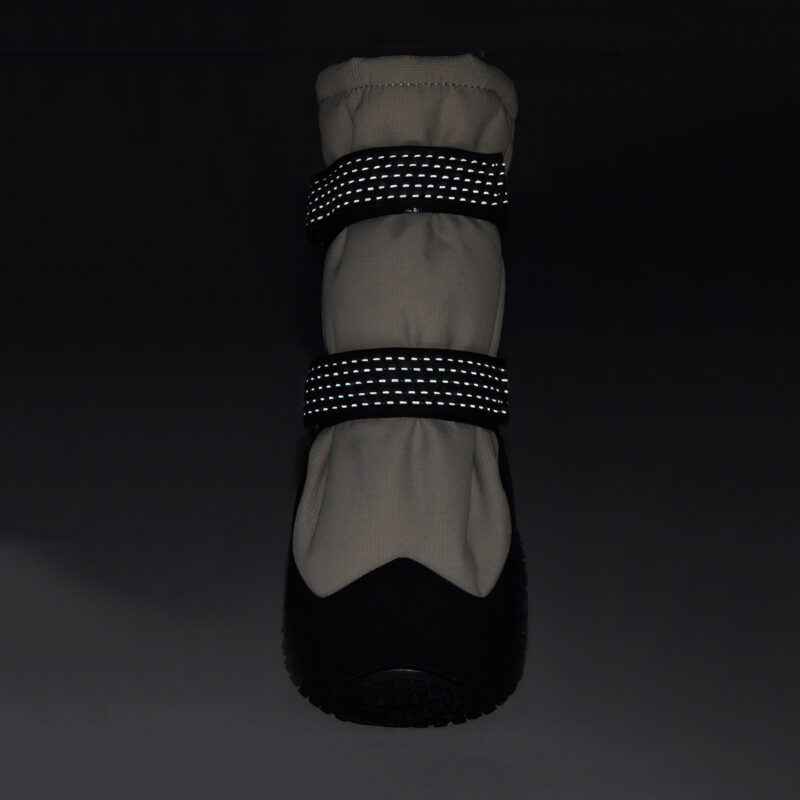 Dual 3M retroreflective straps glowing bright on reflective double-strap shoes under dark environment conditions.
