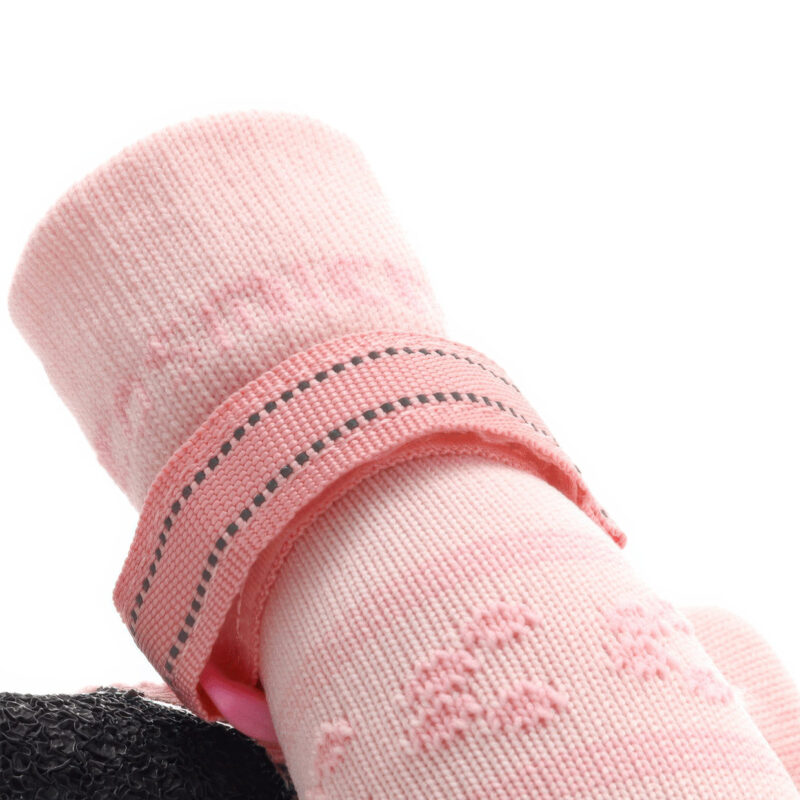 Detailed view of the stretch-knit ankle collar on pink reflective knit dog booties for dry comfort.