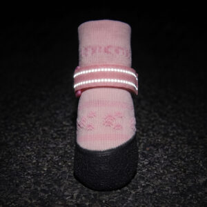 Night reflection test showing highly visible glowing straps of reflective knit dog booties in the dark.