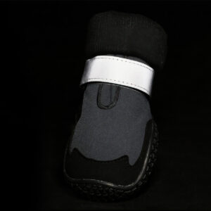 Silver panels glowing bright on reflective protective dog shoes under dark environment conditions for safety.