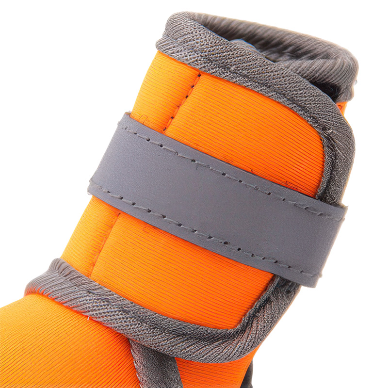 High-luminance silver grey closure band on reflective soft-sole boots showing tight hook-and-loop stitching lines.