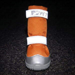 Reflective velcro strap boots in tangerine orange glowing bright under dark night conditions for visibility safety.