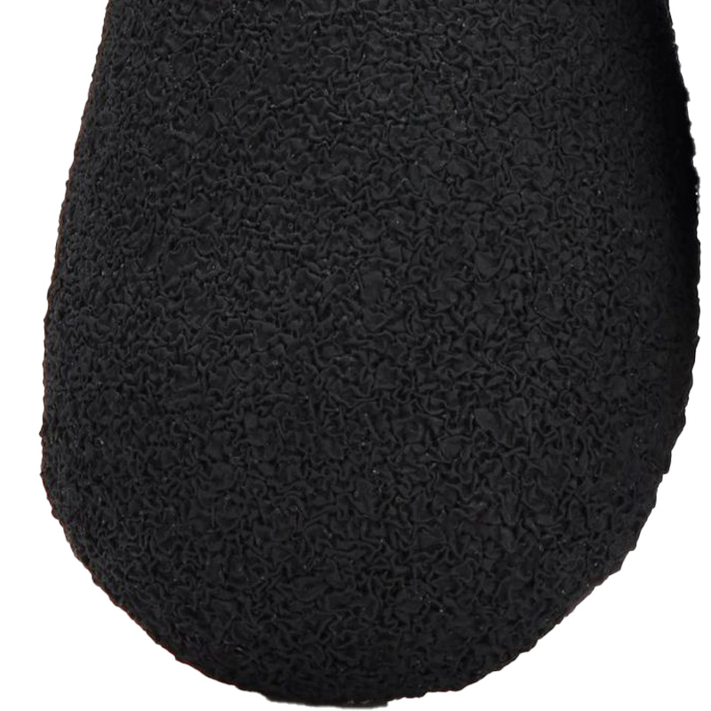 Extreme close-up of the textured slip-resistant vulcanized rubber tread on reflective waterproof dog booties.