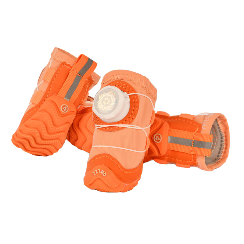 Rear perspective of tangerine orange dog shoes highlighting the vertical silver retroreflective safety tracking band crossing the tab.