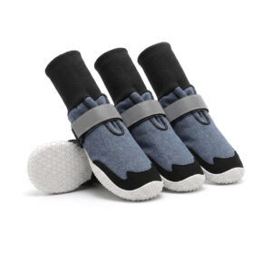 Sock-style dog boots in denim blue featuring flexible black ribbed knit cuffs and non-slip white rubber soles.