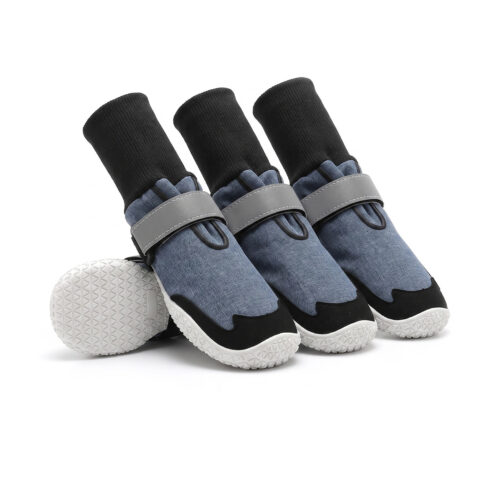 Sock-style dog boots in denim blue featuring flexible black ribbed knit cuffs and non-slip white rubber soles.