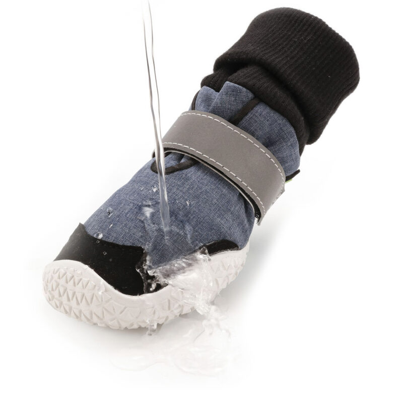 Hydrophobic test on sock-style dog boots showing a clear water stream repelling off the softshell fleece upper.