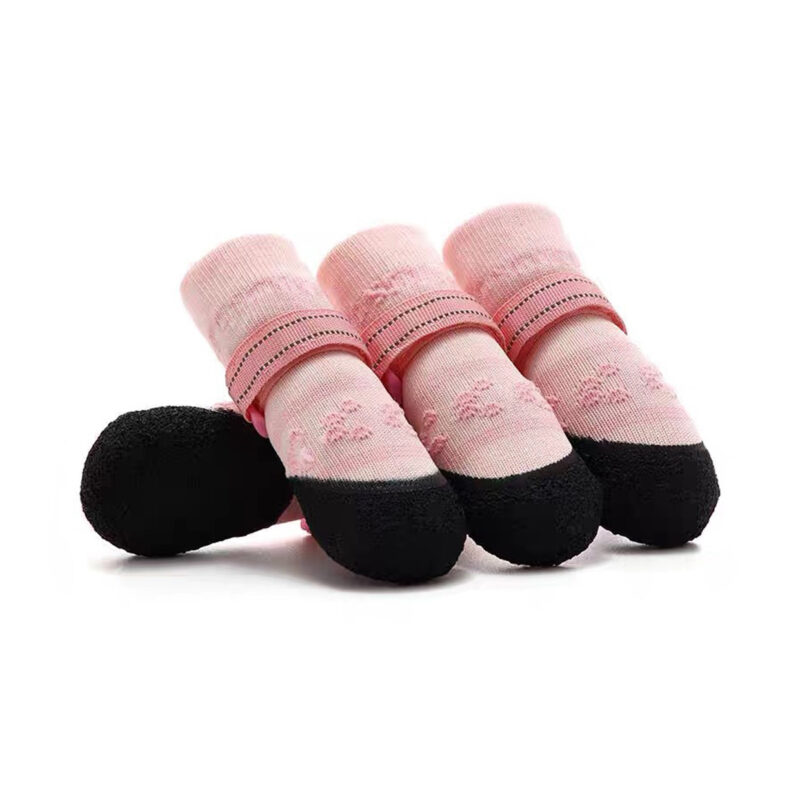 Sakura pink soft-sole dog socks with flexible black protective latex bottoms and adjustable straps.Sakura pink soft-sole dog socks with flexible black protective latex bottoms and adjustable straps.