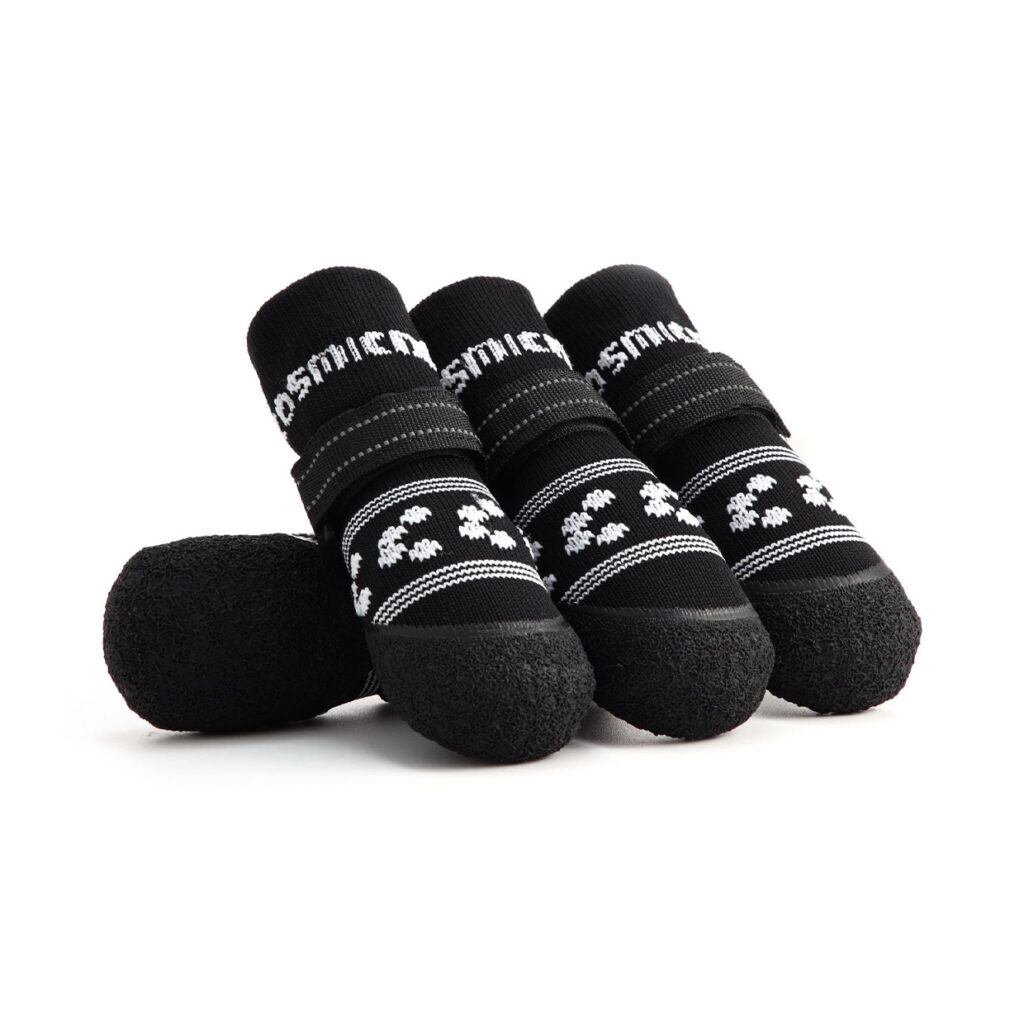 Stealth black soft-sole dog socks with white pattern detailing and reflective secure-fit velcro straps.
