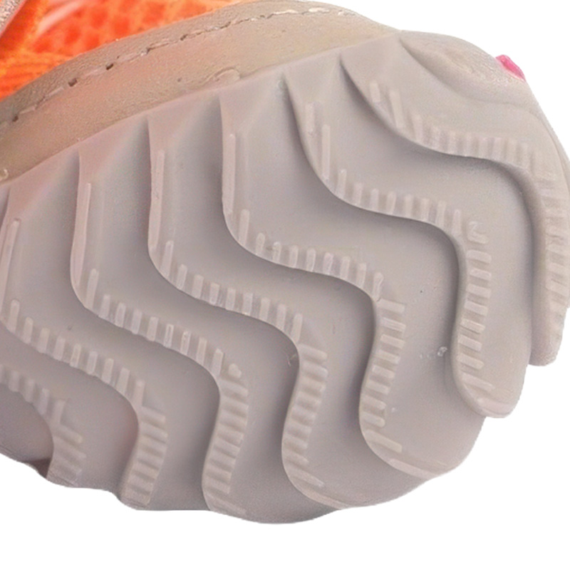 Underneath look at the light grey flexible outsole on soft-sole non-slip paw protectors showing deep wave grooves.
