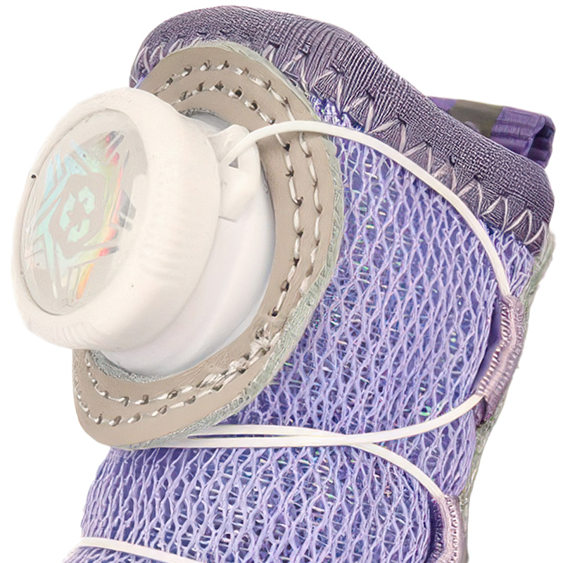 Macro view focusing on the white mechanical tightening dial and glinting purple sequin mesh upper on a dog bootie.