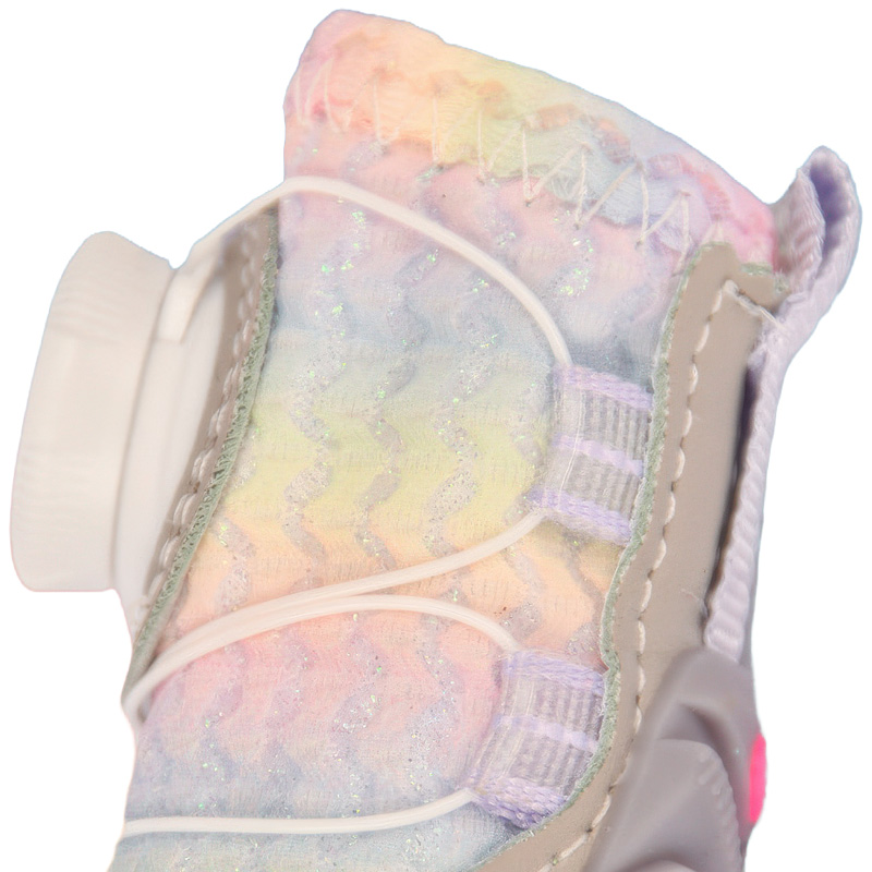 Close profile detail of the wire lace guide tracks and glitter-infused canvas upper paneling on small dog boots.