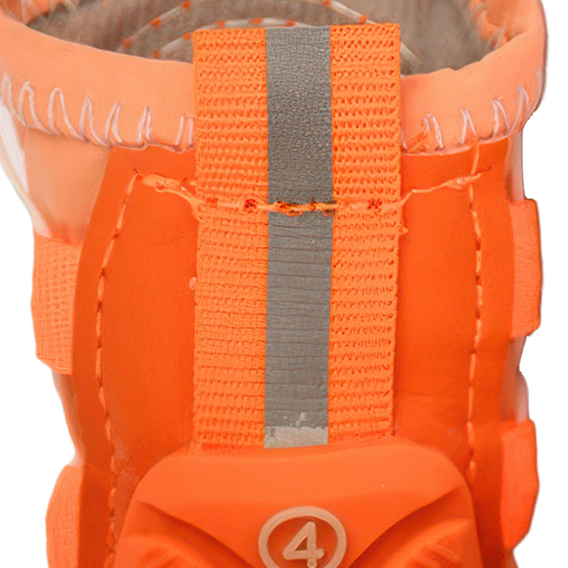 Close up look at the vertical silver retroreflective safety tracking band sewn along the orange heel cuff spine.
