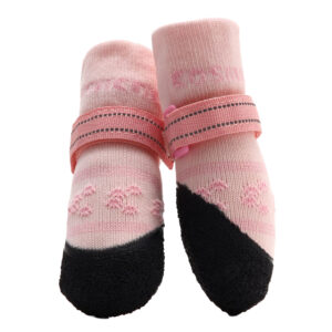 A pair of pink stay-on socks for active dogs showcasing the protective non-slip rubber sole layout.