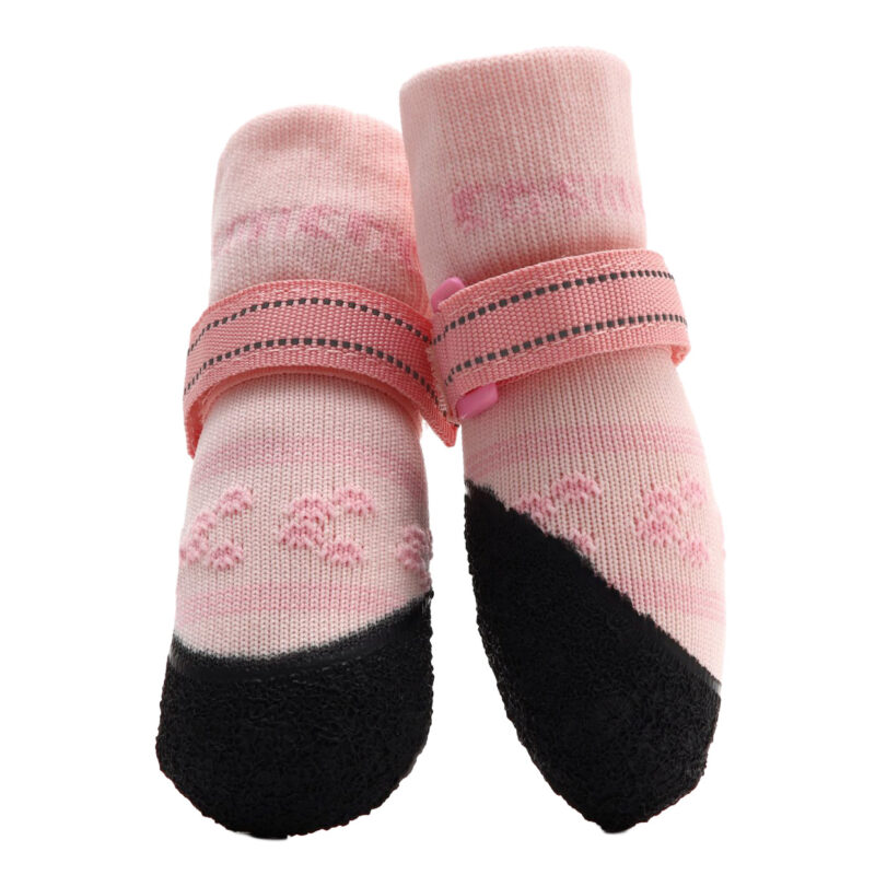 A pair of pink stay-on socks for active dogs showcasing the protective non-slip rubber sole layout.