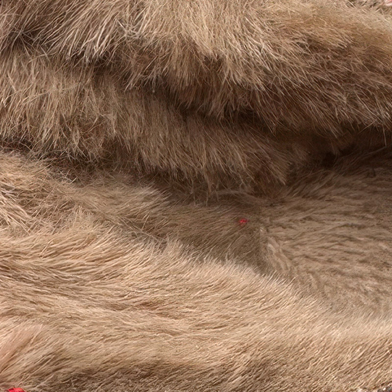 Macro view focusing on the thick tan plush insulation lining the interior core chamber of winter dog boots.