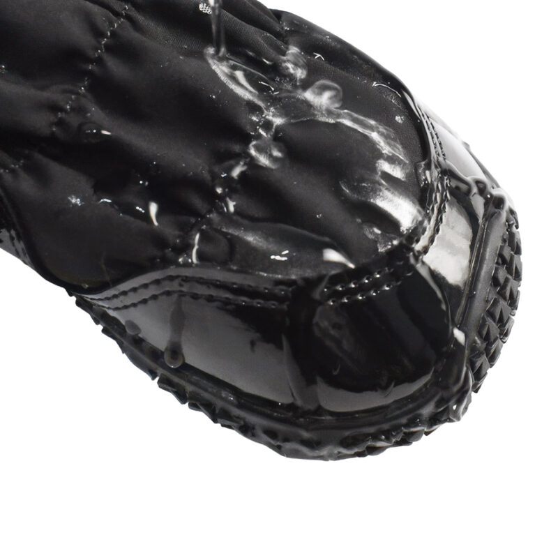 Hydrophobic test on water-resistant winter dog boots displaying water stream beads running off the microfiber toe cap.