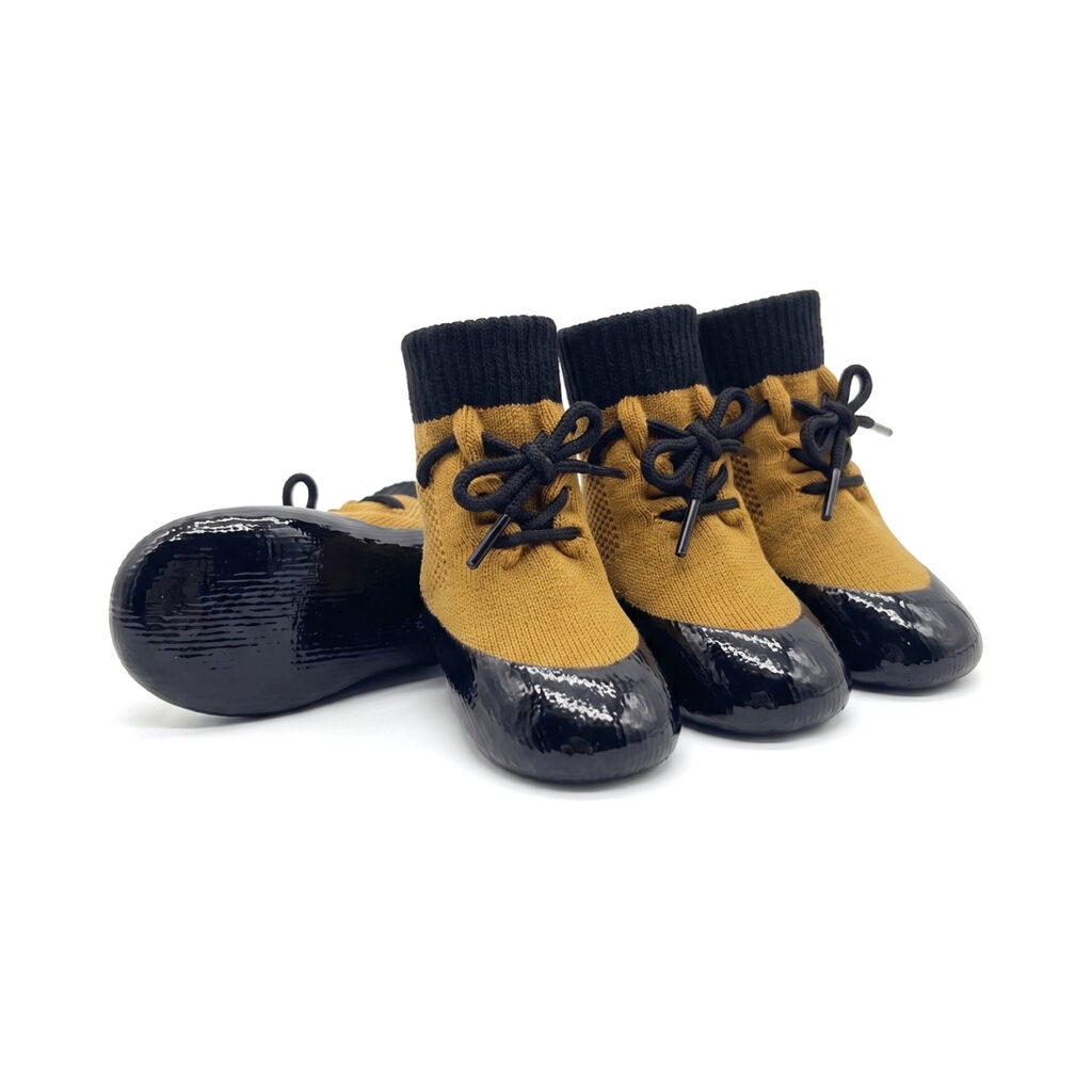 Camel tan waterproof lace-up dog socks featuring a secure black lacing cord and shiny black rubber bases.