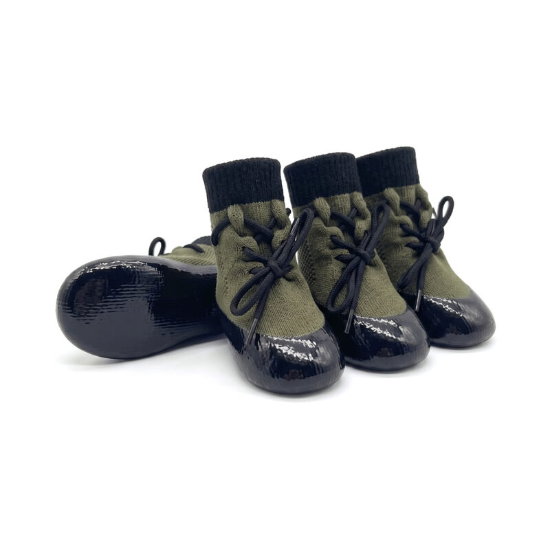 Sage green drawstring knit dog booties with flexible black protective rubber soles for active dogs.