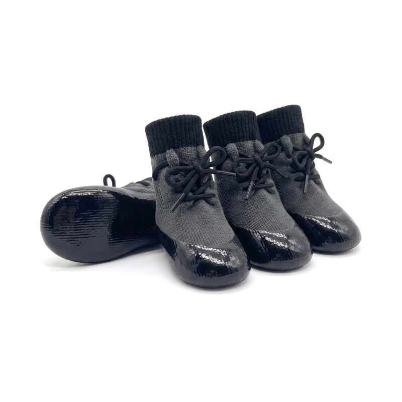Silver gray seamless rubber bottom dog socks with black adjustable laces for hardwood floor slip prevention.