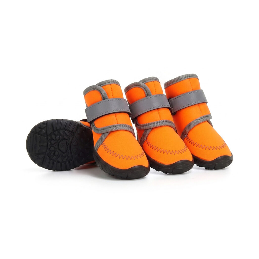 Waterproof neoprene dog boots in tangerine orange featuring four protective booties with black anti-slip rubber soles.