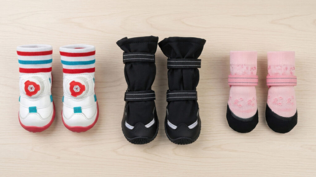 Flat lay product comparison showing lightweight dog walking shoes, heavy-duty waterproof snow boots, and non-slip indoor grip socks.