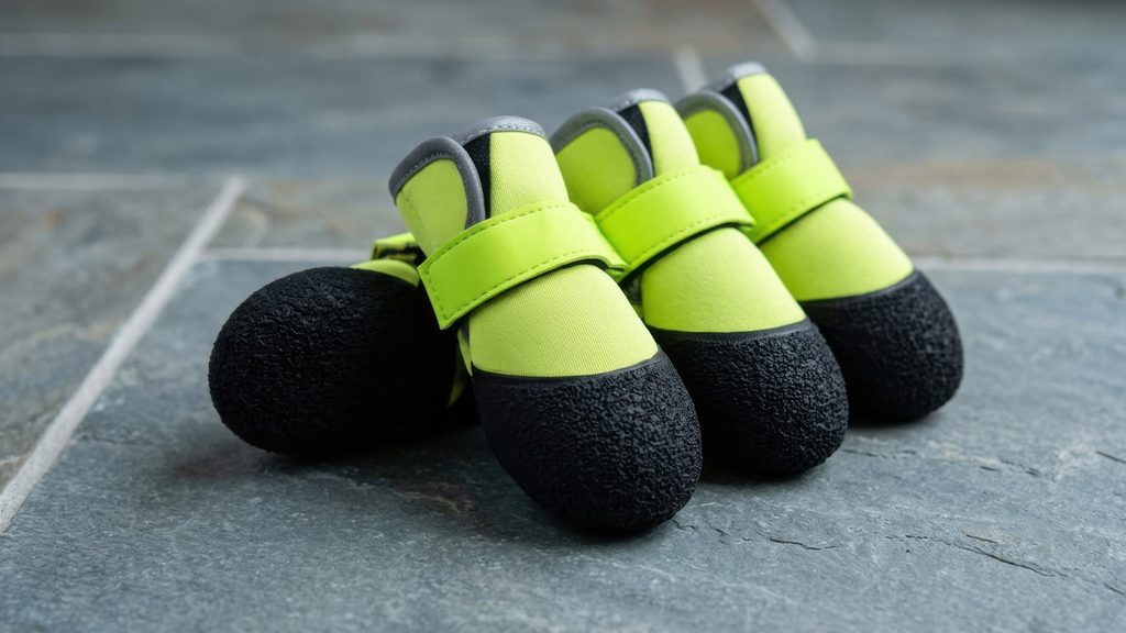 Dog Grooming Shoes: Calm Bath Time & Keep Paws Clean Close-up flat lay of neon yellow neoprene dog grooming boots featuring textured non-slip toe caps and adjustable straps on wet slate.